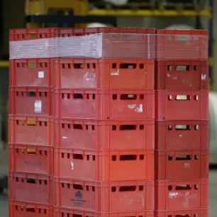 Cardboard boxes secured on pallets with red sanstrap® stretch band