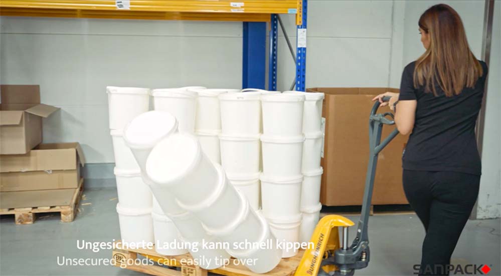 Overturned white buckets on a pallet with no visible securing.