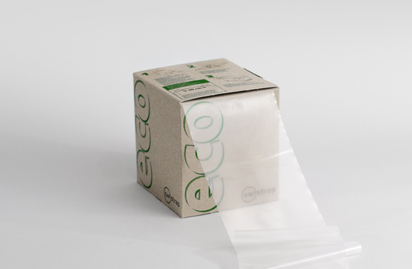 Sanstrap® eco Dehnband-Spenderbox mit umweltfreundlichen Stretchbändern aus Recyclingmaterial.