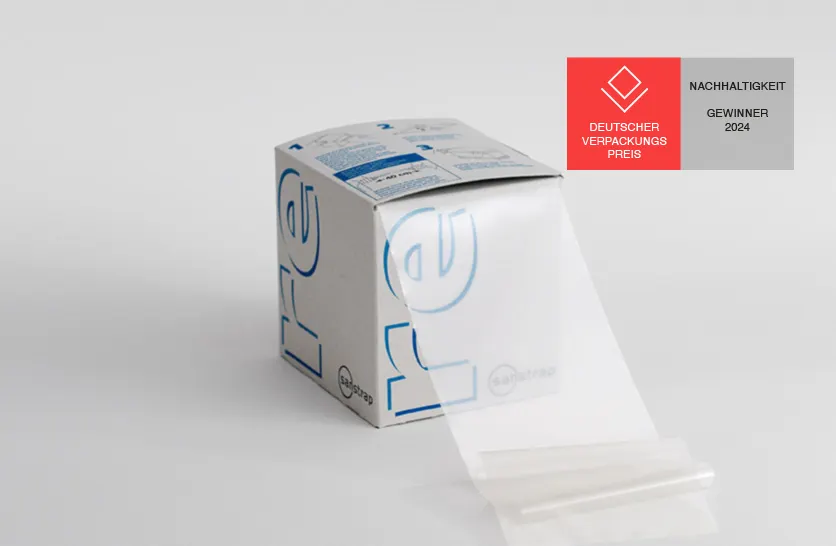 Sanstrap® re Dehnband-Box mit transparentem Dehnband aus recyceltem Kunststoff zur Palettensicherung.
